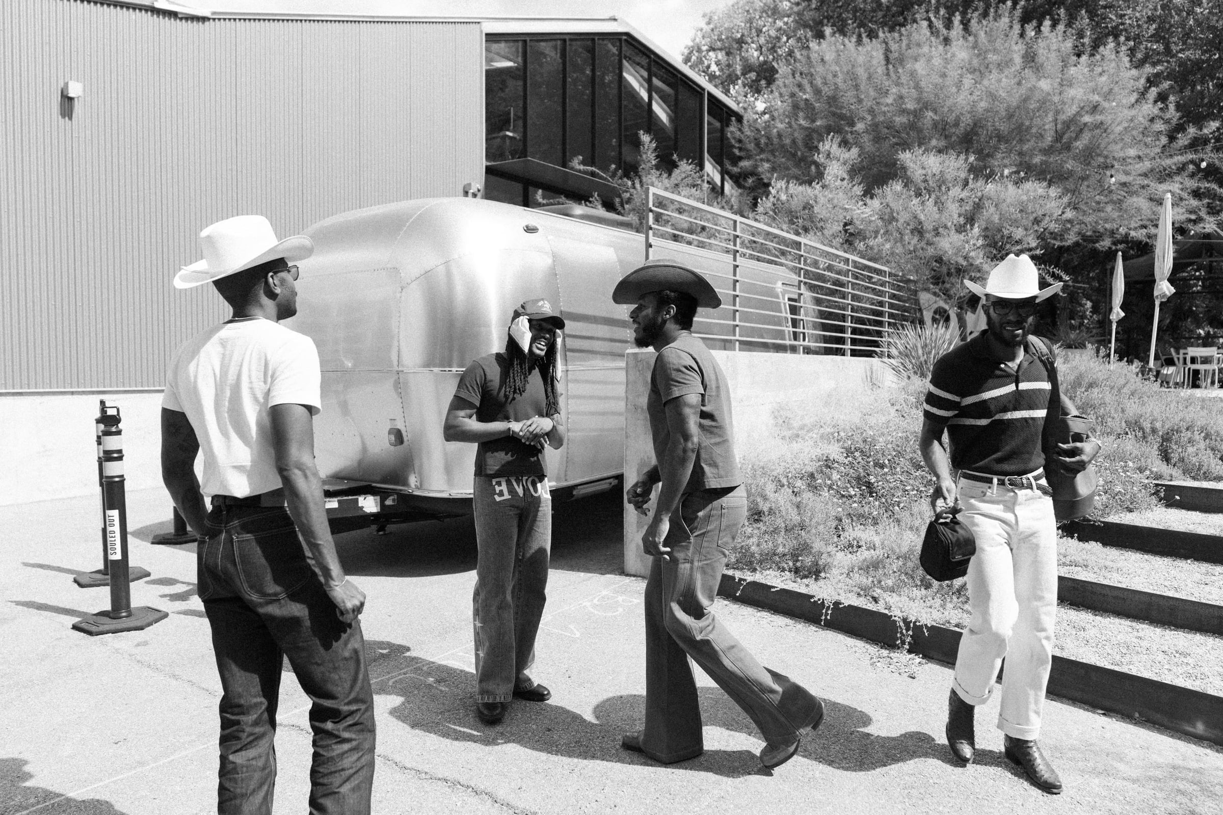 Leon Bridges, The Bros Fresh and Brandon Marcel outside an Airstream between studio sessions — black-and-white documentary photography, Austin TX — Chauncey Scott