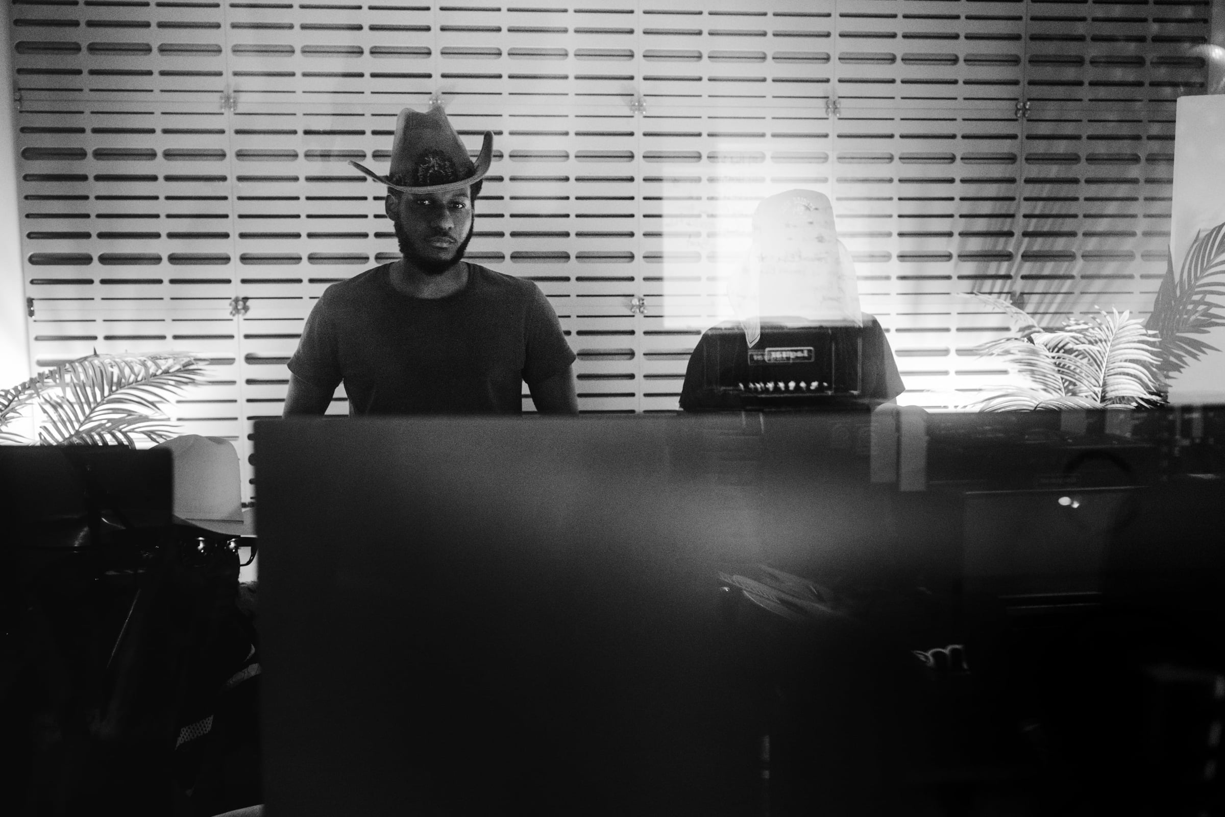 Studio session — a musician at the keys in a wide-brim hat, from the Leon Bridges, The Bros Fresh and Brandon Marcel sessions — black-and-white documentary photography, Austin TX — Chauncey Scott